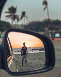 Reflection of cloudy sky on side-view mirror