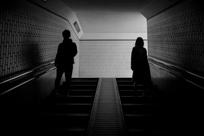 Rear view of silhouette people walking in subway