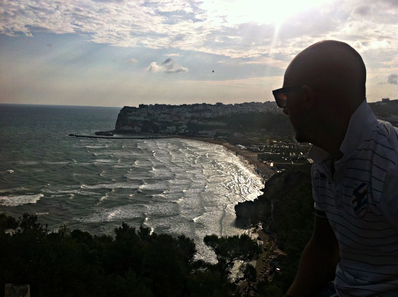 lifestyles, leisure activity, water, sea, sky, standing, rear view, men, silhouette, person, rock - object, scenics, tranquil scene, full length, beauty in nature, nature, looking at view, cloud - sky