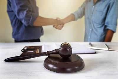 Midsection of lawyer working on table