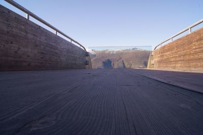 Surface level of road against clear sky