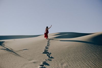 Full length of senior man on desert against clear sky