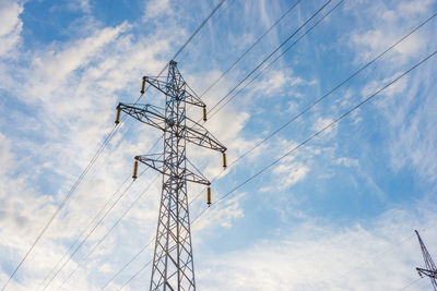 Low angle view of electricity pylon against sky