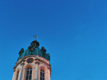 Low angle view of statue against blue sky