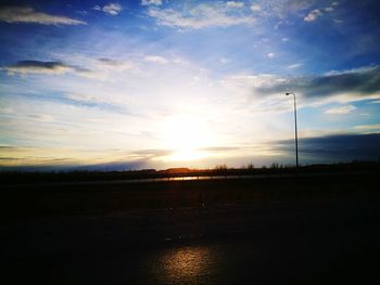 Scenic view of field against sky at sunset