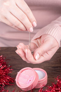 Midsection of woman holding christmas decoration