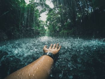 Cropped hand in steam during rainy season