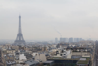 Aerial view of buildings in city against sky