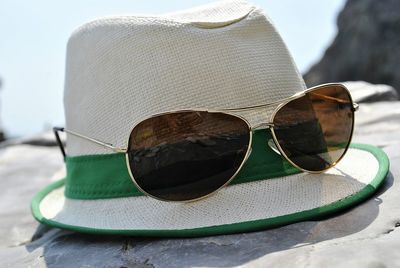 Close-up of sunglasses against sky