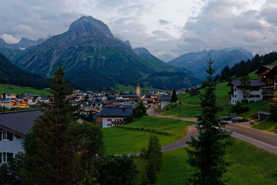 Houses and buildings in town against sky