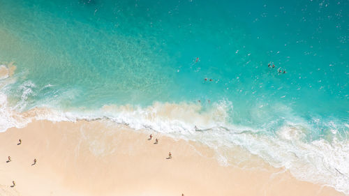 High angle view of waves rushing towards shore