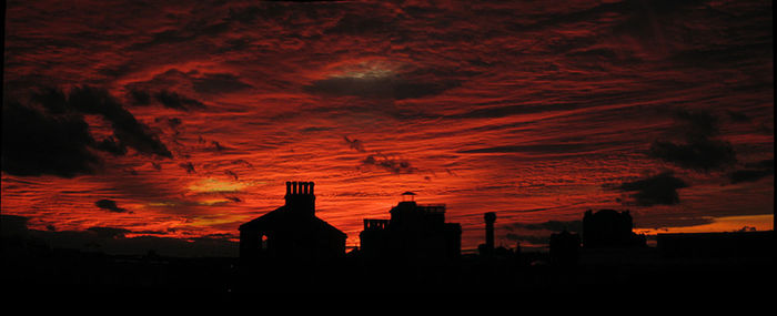 Silhouette of built structure against dramatic sky