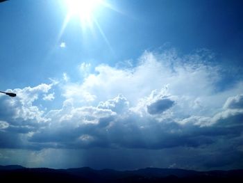 Low angle view of bright sun in sky