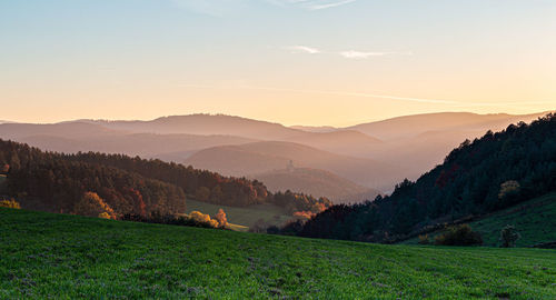 Scenic view of field against sky during sunset