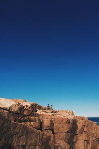 Rock formations against clear blue sky