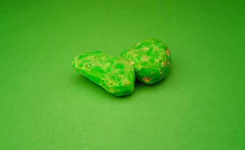 Close-up of green pepper against colored background