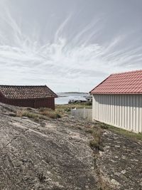 House on shore against sky