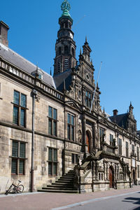 Low angle view of building against blue sky