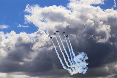 Low angle view of air show against sky