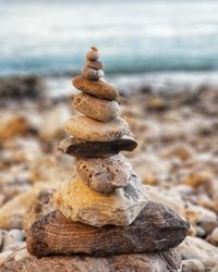 Close-up of stones stacked at beach