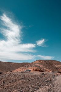 Scenic view of desert against blue sky