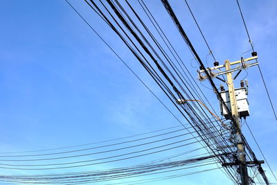 Low angle view of electricity pylon against sky