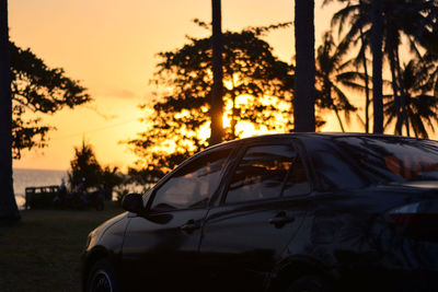 Car on street against sky during sunset