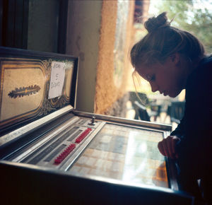 Close-up of woman working in window