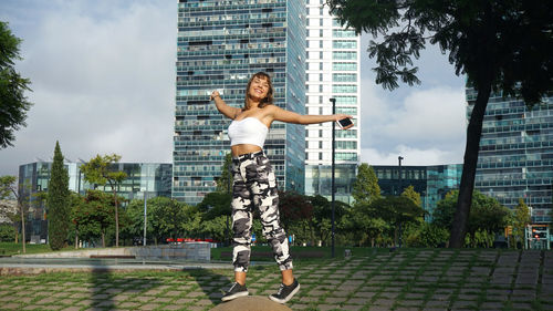 Teenage girl standing building in city