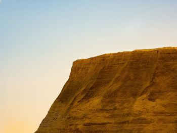 Low angle view of rock formations against sky