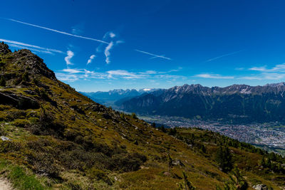 Scenic view of mountains against blue sky