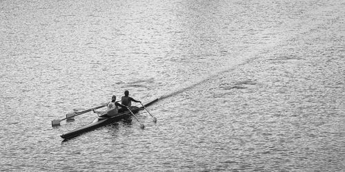 High angle view of people rowing boat in lake