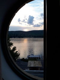 Scenic view of lake seen through glass window