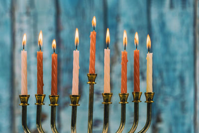 Close-up of lit candles in temple