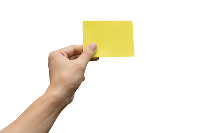 Midsection of person holding paper against white background