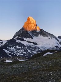 Scenic view of snowcapped mountains against clear sky