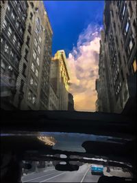 Reflection of buildings in swimming pool against sky