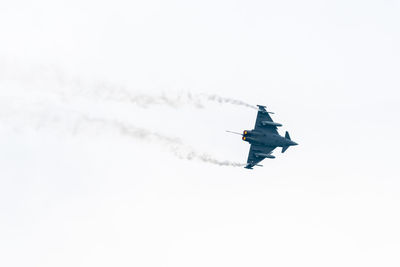 Low angle view of airplane flying against sky