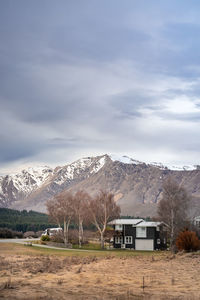 Sunrise view of the housing estate at lake tekapo in late winter with beautiful snow capped mountain
