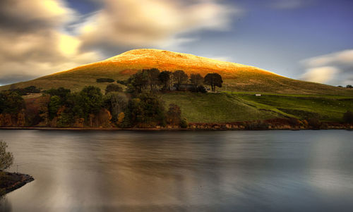 Scenic view of lake against sky during sunset