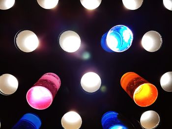 Low angle view of illuminated lanterns hanging at night