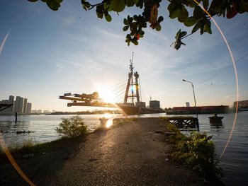 View of bridge over river against cloudy sky