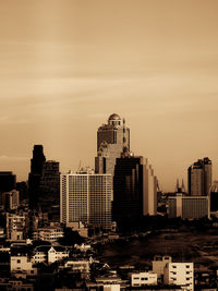 Bangkok city tall buildings by the chao phraya riverside in brown monochrome