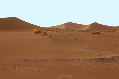 Scenic view of desert against clear sky