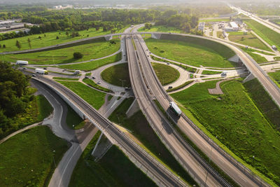 Cars moving on transport road junction in city, aerial view