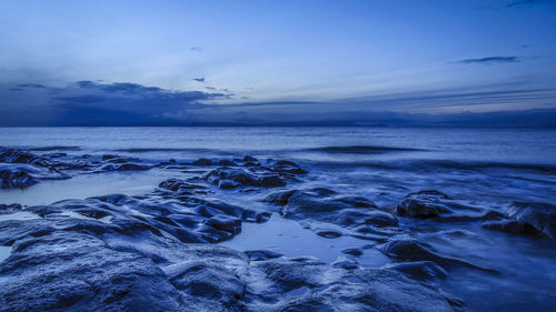 Scenic view of sea against sky at dusk