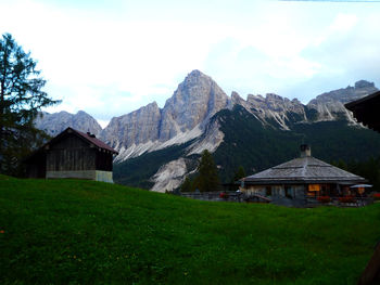 Houses on field against sky