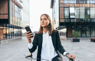 Portrait of young woman using mobile phone