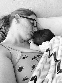 Close-up of baby lying down on bed at home