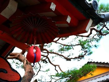 Low angle view of red umbrella against the sky